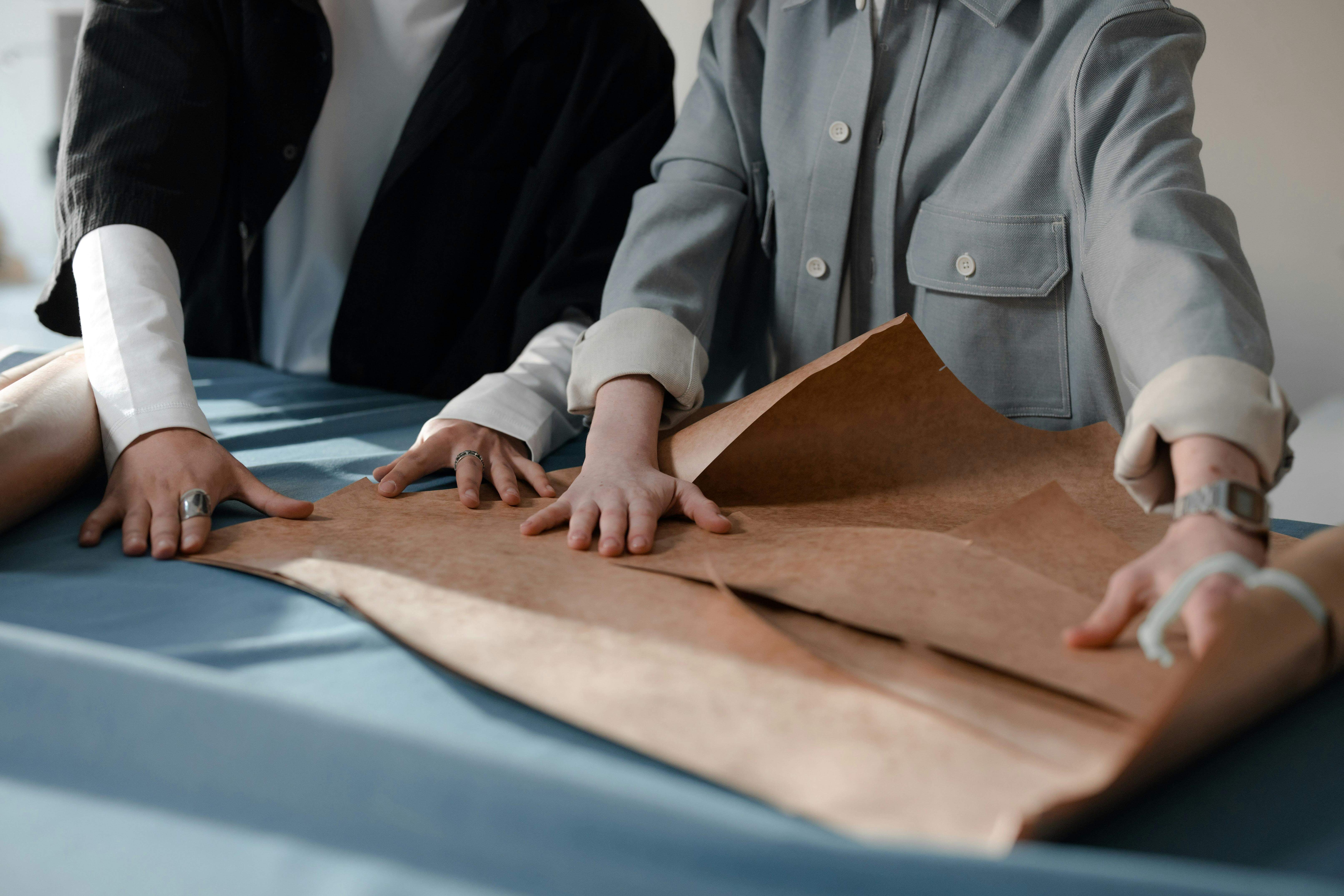 Tailor performing invisible repairs on clothing for seamless restoration